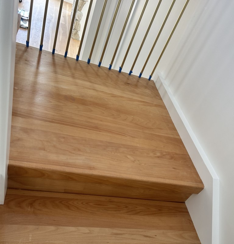 Timber stair treads and landing with white painted trim and balustrade