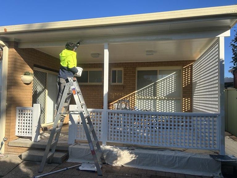 YAS painter working on exterior timber and eaves